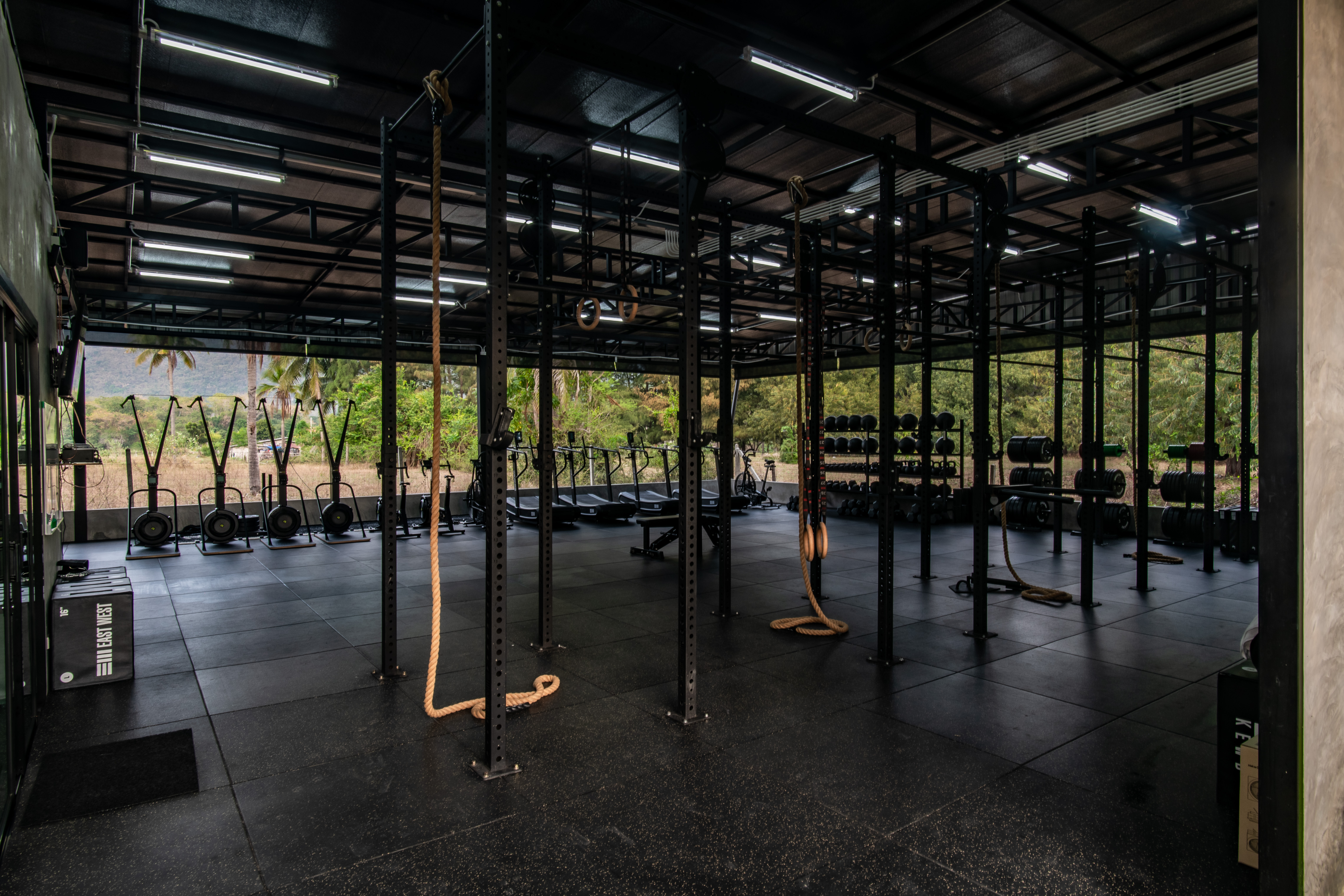 The functional fitness area with sandbags and rigs