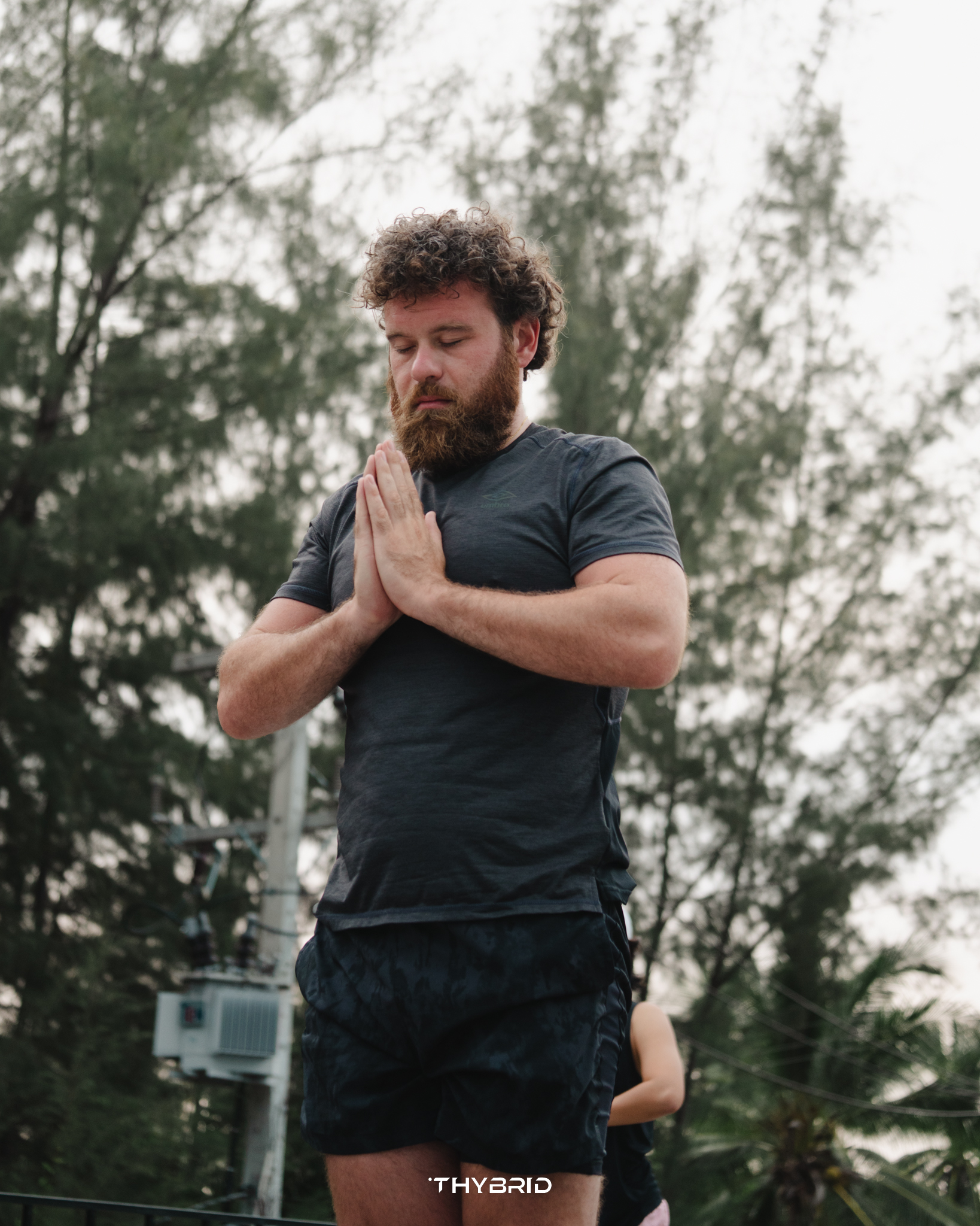 A guest holding a yoga pose in the training space